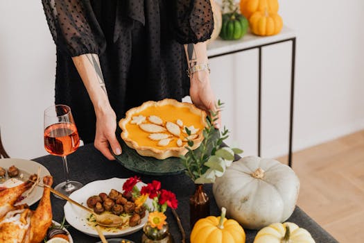 A warm Thanksgiving setup featuring pumpkin pie and festive decor for a cozy celebration.
