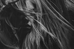 Artistic black and white portrait photography emphasizing mood and expression.